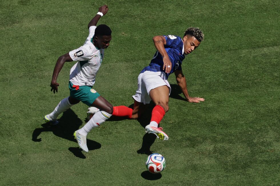 El senegalés Lamine Camara (izquierda) y el francés Desire Doue pugnan por el balón durante el...