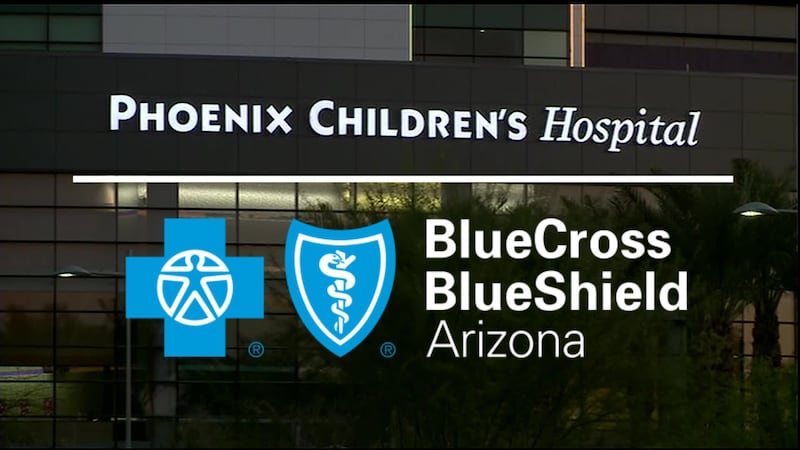 Evening view at Phoenix Children's Hospital sign at entrance. Below the sign is the logo for...